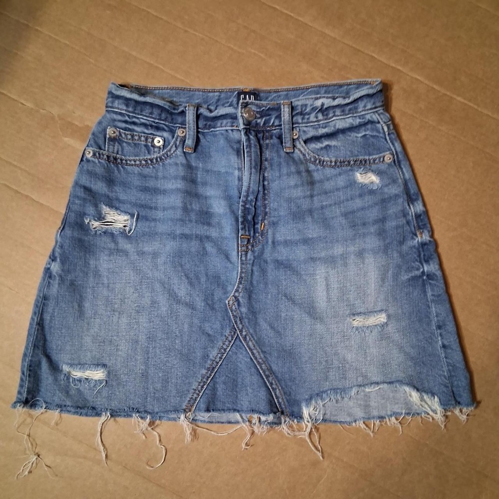 Womens blue denim mini skirt with heavy distressing details
